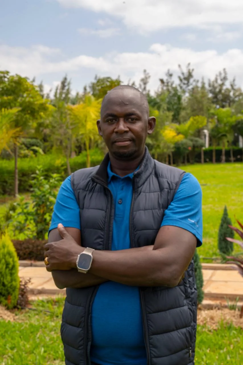 The FKLM Africa Foundation Founder, Festus KL Mwaniki, standing in a garden landscape.
